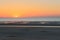 A sunset plunging into the cloudless Sea On the beach of dunkerque