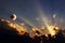 Sunset with rays of light and rising moon with lunar eclipse in the evening sky