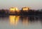 Sunset rays reflected on the windows of buildings and in the river