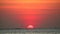 Sunset on red clear sky on light orange cloud on the sea