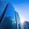 Sunset reflected off modern glass facades of Busy modern city life buildings in morning