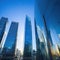 Sunset reflected off modern glass facades of Busy modern city life buildings in morning