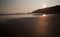 Sunset reflected in the ripples and wet sands of Threecliff Bay, The Gower, South Wales