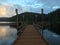 Sunset reflecting on a calm lake with deck in the foreground