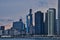 Sunset reflecting off of skyscrapers, with view of sailboats in a Lake Michigan marina in foreground, along Lake Michigan`s lakefr