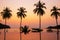 Sunset reflecting on the water surface foreground with coconut trees area ao bang bao at Koh kood island is a district of Trat