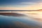 Sunset reflections on a tidal beach