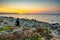 Sunset Reflections: Tranquil Moments on Rethymno\'s Rocky Shore