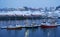 Sunset in Reine Resort in Lofoten Archipelago. Houses and docked fishing boats.