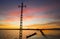 Sunset in rice field flooded with water with path and electric tower, Valencia, Spain