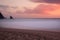 Sunset at rocky coastline of Adraga beach