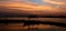 Sunset with romantic boat and silhouette clouds