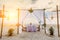 Sunset and romantic luxury dinner at tropical beach. Decorated table with vine glasses. White and magenta tones