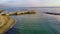 Sunset Rome aerial view in Ostia Lido beach over blue sea and brown sand, beautiful coast line with glimpse of pedestrian pier a