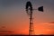 Sunset in a rural outback Australian farm silhouetting a wind pump