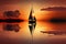 sunset sailboat on tranquil lake, with reflection and serenity