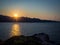 Sunset in Saint Florent Corsica â€“ France â€“ silhouette of a parasailing in background