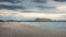 Sunset on San Teodoro sand beach with turquoise sea water and mountains of island Tavolara in Sardinia Italy