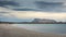 Sunset on San Teodoro sand beach with turquoise sea water and mountains of island Tavolara in Sardinia Italy