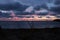 Sunset from the sand dunes of croyde bay looking out over the beach to Lundy island nestled in the sea in the far distance