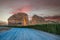 Sunset sandstone elephant rock erosion monolith standing in the desert, with road in foreground, Al Ula, Saudi Arabia