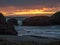 Sunset at sandy beach with sea stacks