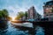 Sunset scene in Amsterdam city. Great Tourist boat on the famous Dutch canal floating tilted houses. Colorful evening