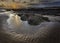 Sunset scene on beautiful rocky beach in Freshwater West on Pembrokeshire coast,South Wales, UK