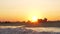 Sunset scene of man relaxing in inflatable sunbed at the seaside