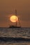 Sunset scene with sailboat