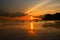 Sunset sea beach with long tail boat silhouettes