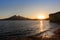 Sunset by the sea, Mediterranean landscape at the coast, sun reflected at the beach. Cabo de Gata, AlmerÃ­a, Andalusia, South of