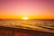 Sunset at sea. Warm sunny sunset over the sea. Sea waves. The sun sets over the horizon