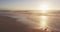 Sunset and sea with waves and blue sky on empty sunny beach