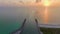 Sunset seascape of rock jetty barrier and boats sailing at harbor on colorful ocean water near Venice and Nokomis beach