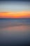 Sunset seascape. Slow shutter speed. Colorful sky. Amazing water reflection. Nature and environment background. Soft focus. Silky