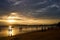 Sunset on the seashore.People are looking for beautiful shells on the bottom at low tide