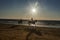 Sunset on the seashore with silhouettes of a riders on horses.