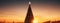 Sunset Serenade with Christmas Star A majestic Christmas tree adorned with a star, silhouetted against the breathtaking canvas of