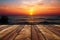 Sunset serenity Wooden table against the beauty of a sea sunset