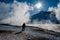 Sunset shadows, man stands at steaming geothermal lake, Namafjall  near Myvatn, Iceland