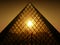 Sunset shining through Louvres pyramid