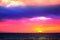 sunset and ship on horizontal ocean water surface colorful cloud