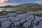 A sunset shot of the stunning and mars like landscape that is The Burren National Park, County Clare, Ireland with small lake in