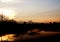 Sunset and silhouette of buildings, transmitter towers, cranes with a mountain background