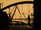 Sunset silhouette of Couple on Hamburg bridge with lovelocks and industrial theme