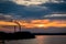 Sunset silhouette of industrial plant with a smoking pipe located on a river