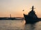 Sunset. Silhouette of a military ship at anchor