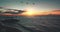 Sunset silhouette of ship at ocean coast aerial. Sun lens flare over evening seascape. Boat at sea