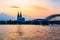 Sunset silhouette skyline landscape of the gothic Cologne Cathedra, Hohenzollern railway and pedestrian bridge, the old town and
